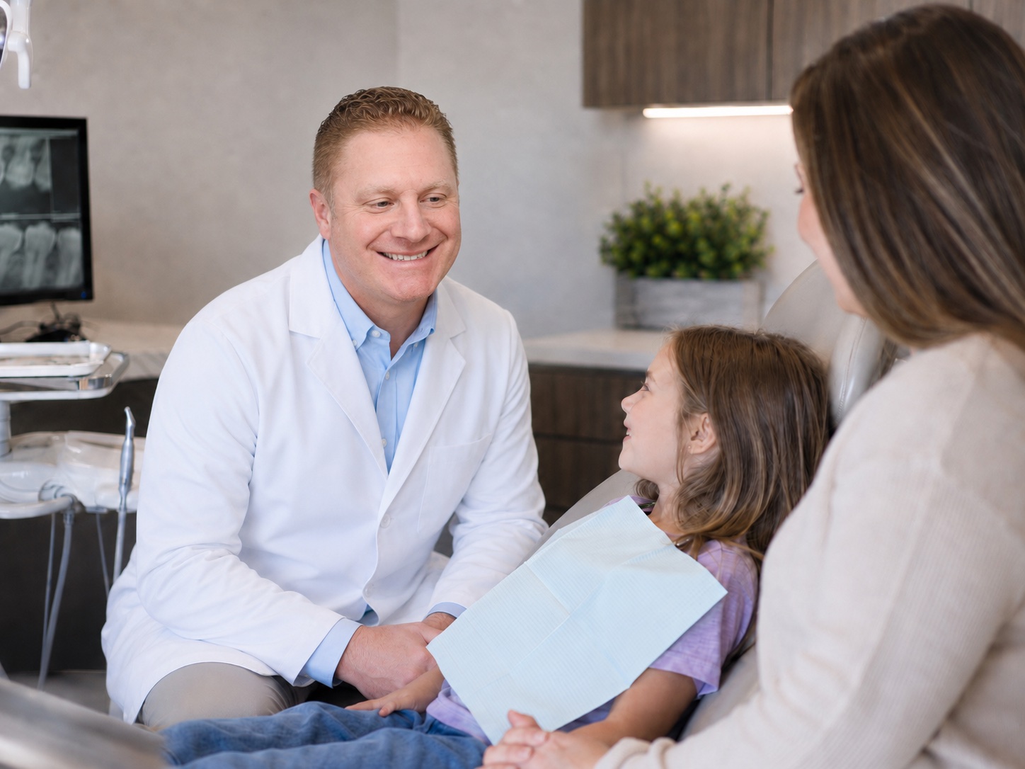Dr. Steven Bauman reviewing dental X-rays with a senior patient, restorative treatment planning at Dunning Family Dental in Johnstown, NY.